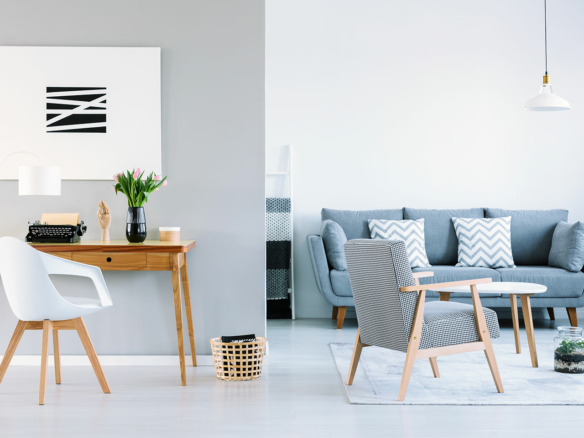 Stylish Ulcinj living room: grey sofa, chic decor, workspace—invest in Montenegro property with immobilien.ekosphere.me by Ekosphere DOO.