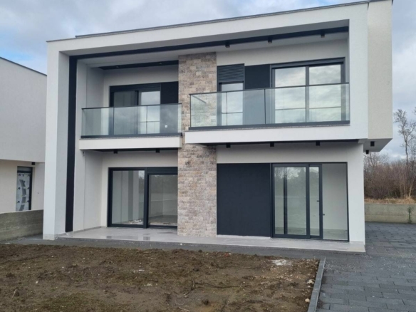Contemporary two-story home in Ulcinj, Montenegro with glass balcony and stone features&mdash;exclusive on immobilien.ekosphere.me by ekosphere doo.
