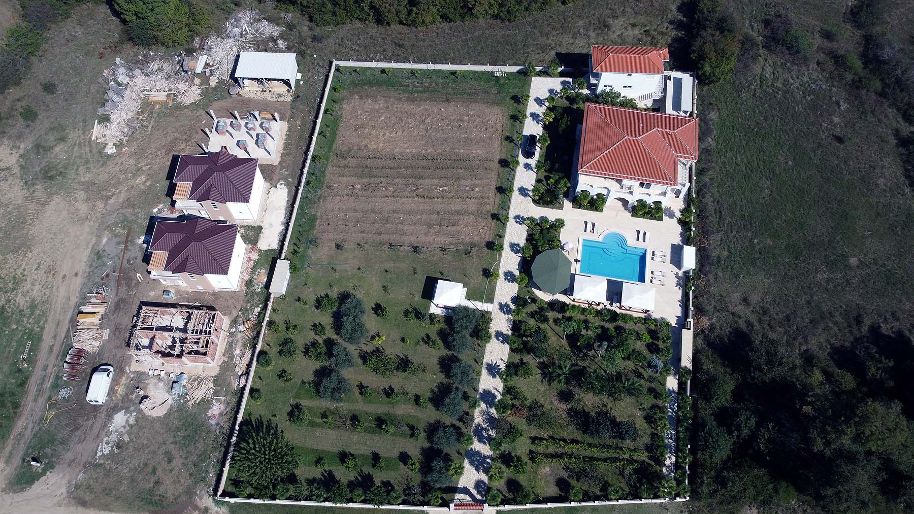Stunning aerial view of gated Ulcinj property: two red-roof homes, pool, gardens&mdash;prime real estate by ekosphere doo, invest now!.
