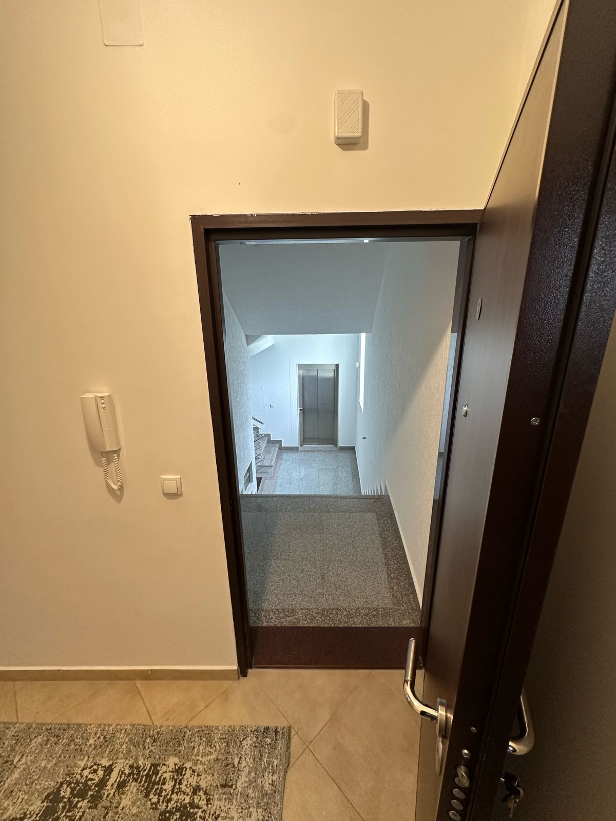 Modern tiled hallway with elevator and stairs, secure entry intercom&mdash;prime Ulcinj real estate. immobilien.ekosphere.me by Ekosphere doo.