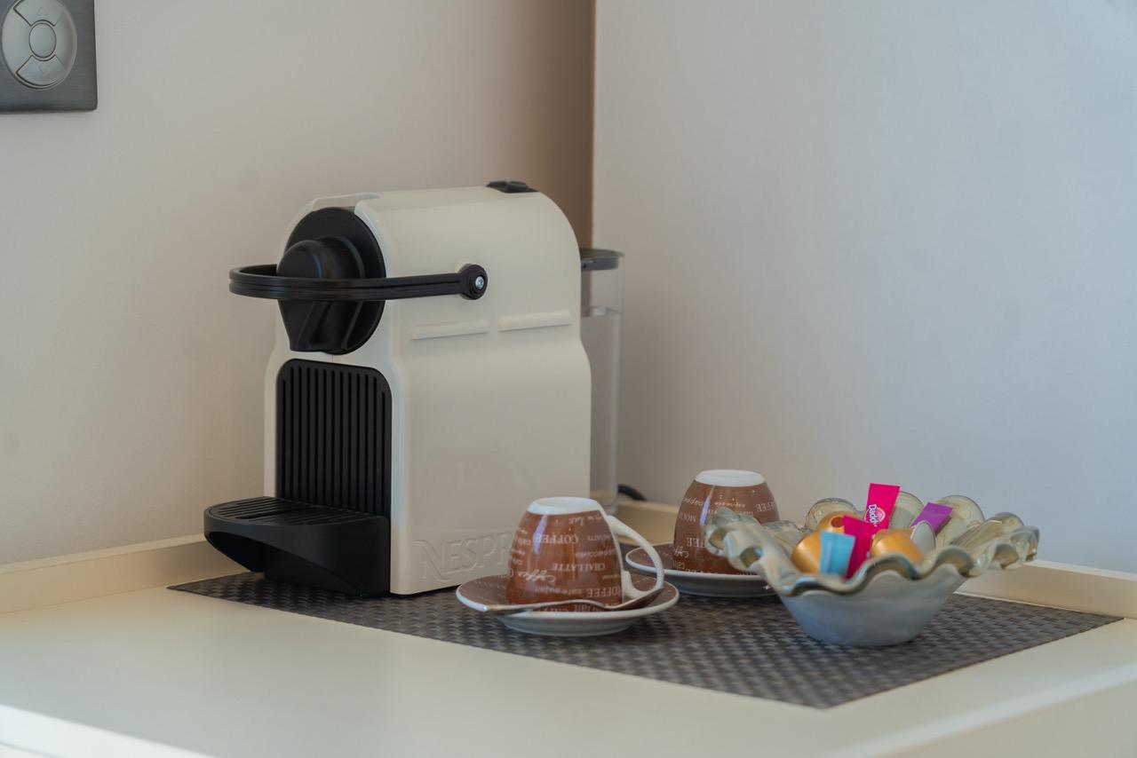 Modern white espresso machine and coffee setup creates a welcoming touch in Ulcinj properties&mdash;find your dream home with Ekosphere doo.