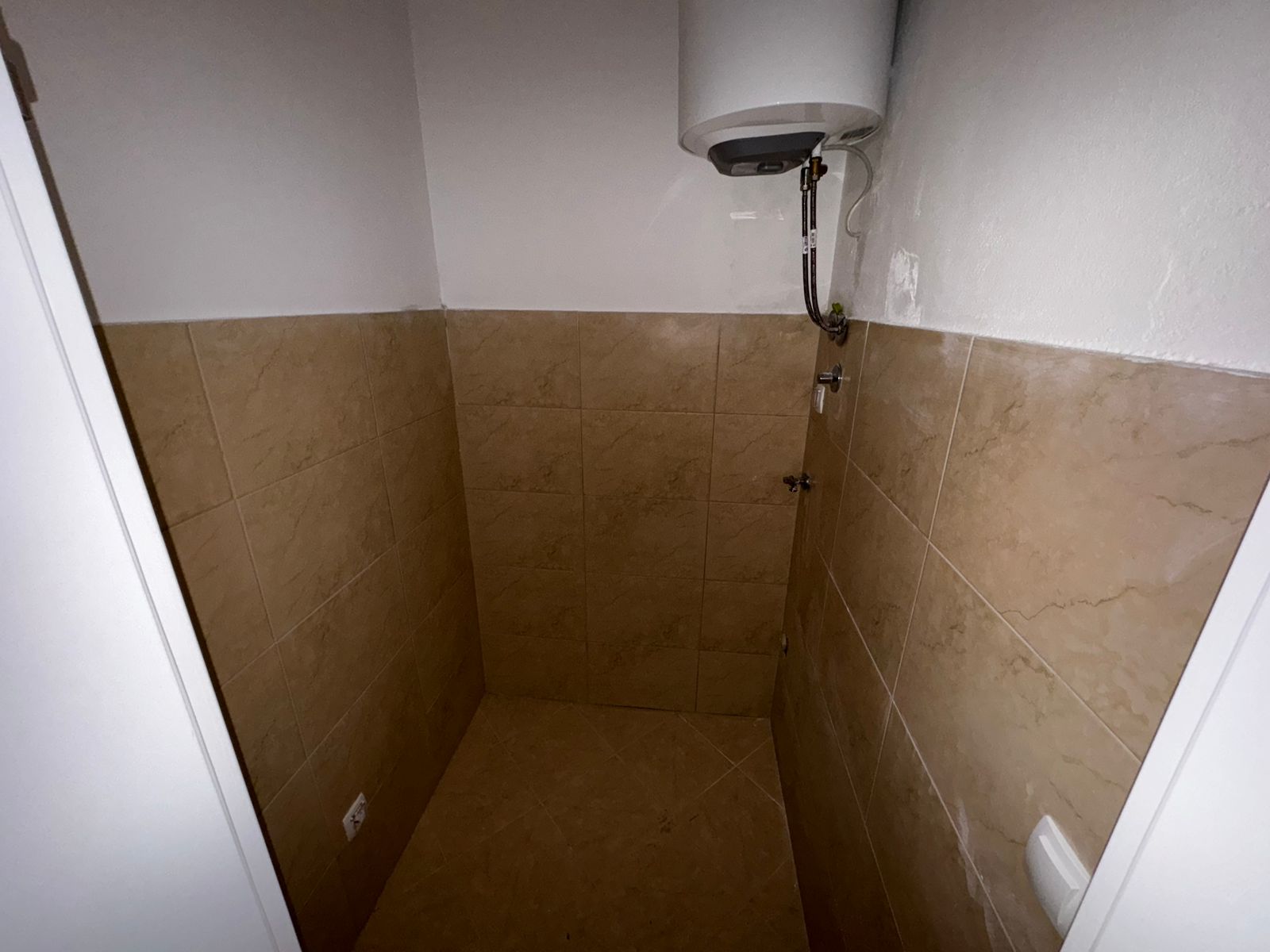 Bright, tiled utility room in Ulcinj, Montenegro with water heater&mdash;ideal investment, eco-friendly; on immobilien.ekosphere.me by ekosphere doo.