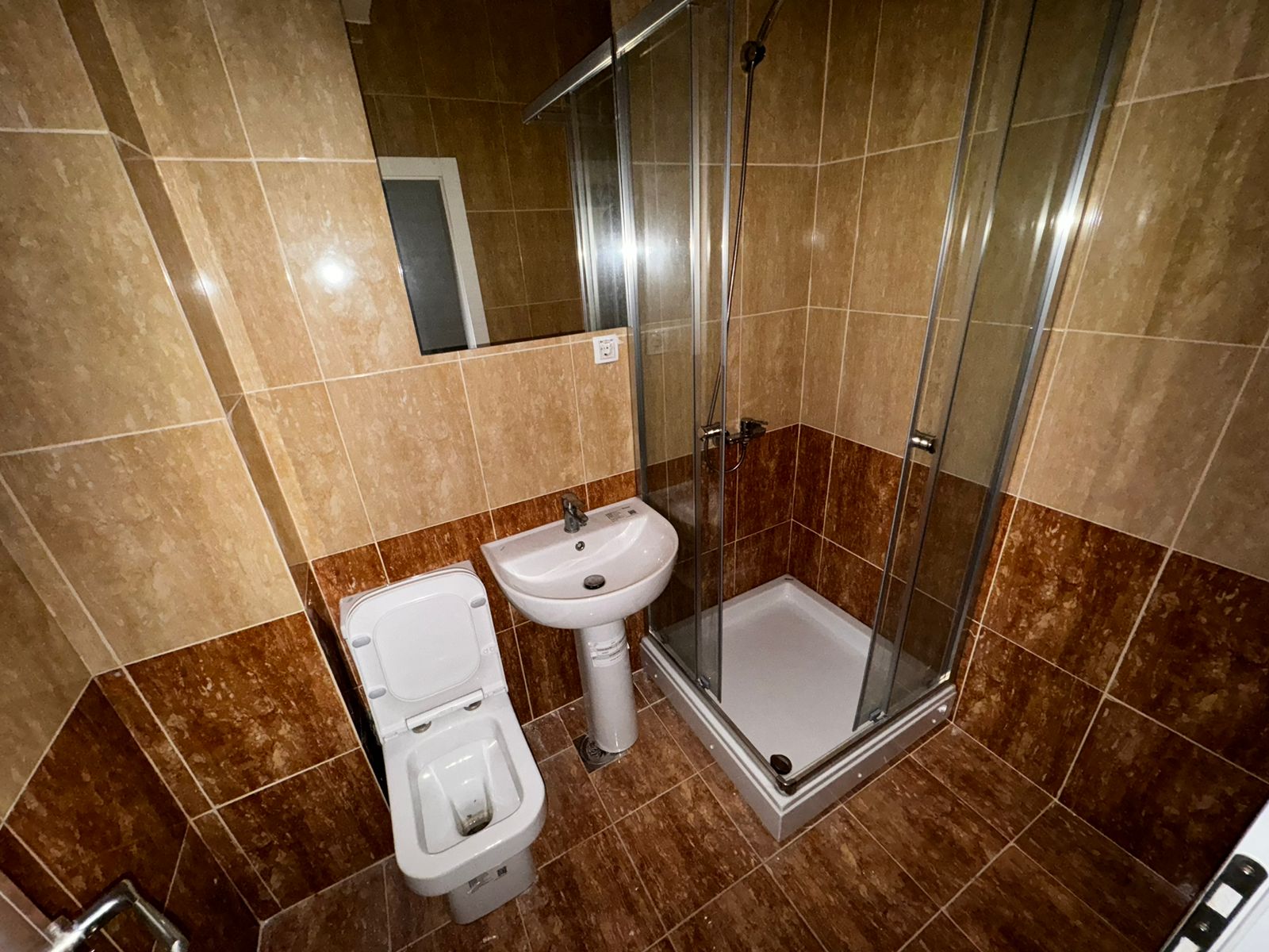 Modern Ulcinj bathroom with stylish tiles, glass shower, and quality fixtures. Exclusive at immobilien.ekosphere.me by ekosphere doo.