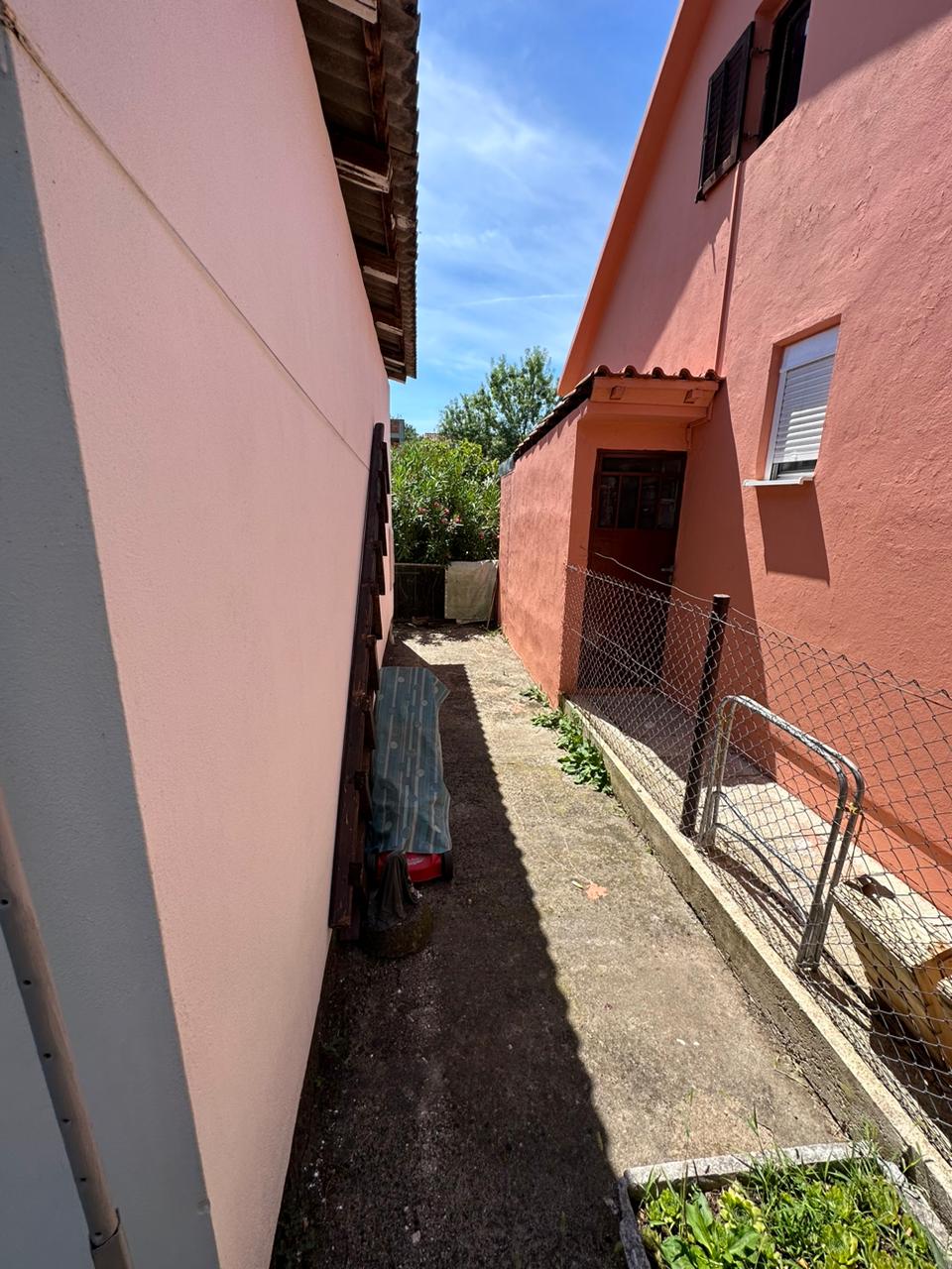 Charming Ulcinj investment: concrete pathway between pink properties, fenced garden. Exclusive on immobilien.ekosphere.me by ekosphere doo.