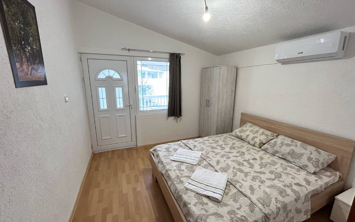 Charming Ulcinj bedroom for sale: double bed, AC, wardrobe, bright windows&mdash;prime Montenegro real estate via immobilien.ekosphere.me.