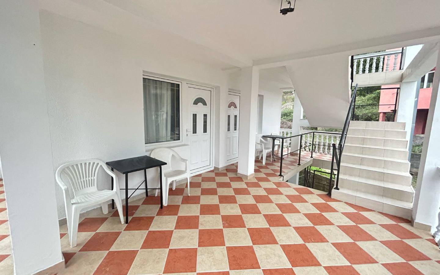 Discover this Ulcinj, Montenegro property: covered corridor, stylish checkered floor, modern seating&mdash;exclusive on immobilien.ekosphere.me.