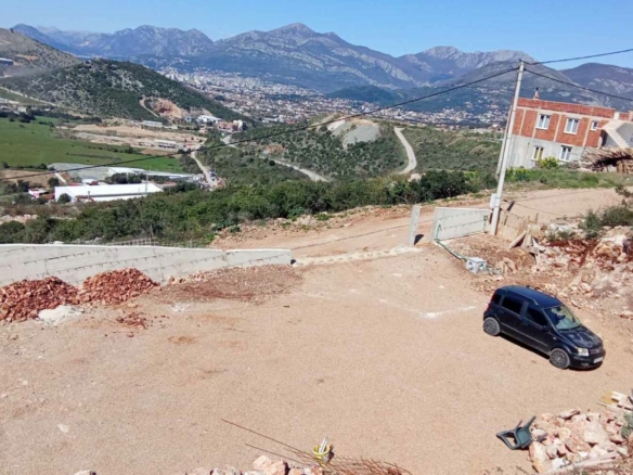 Prime Ulcinj, Montenegro investment: half-built home, gravel parking, mountain views. Listed by immobilien.ekosphere.me (ekosphere doo).