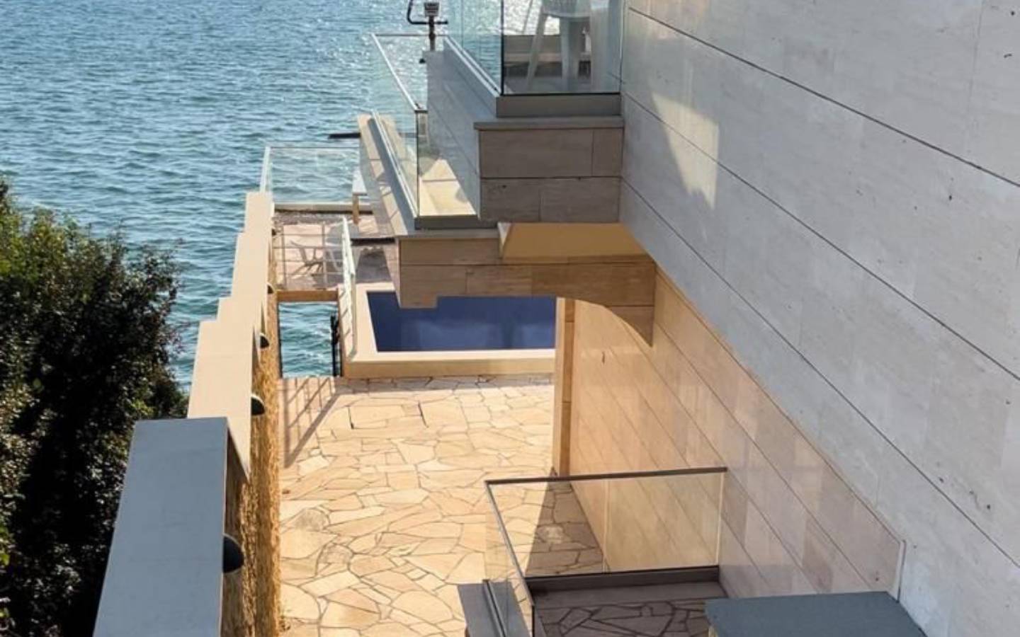 Waterfront modern home in Ulcinj with pool, stone patio, and glass railings&mdash;exclusive at immobilien.ekosphere.me by Ekosphere d.o.o.