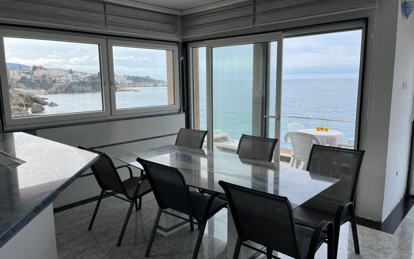 Elegant dining area with glass table, sea views, and modern design in Ulcinj&mdash;exclusive real estate from immobilien.ekosphere.me by Ekosphere.