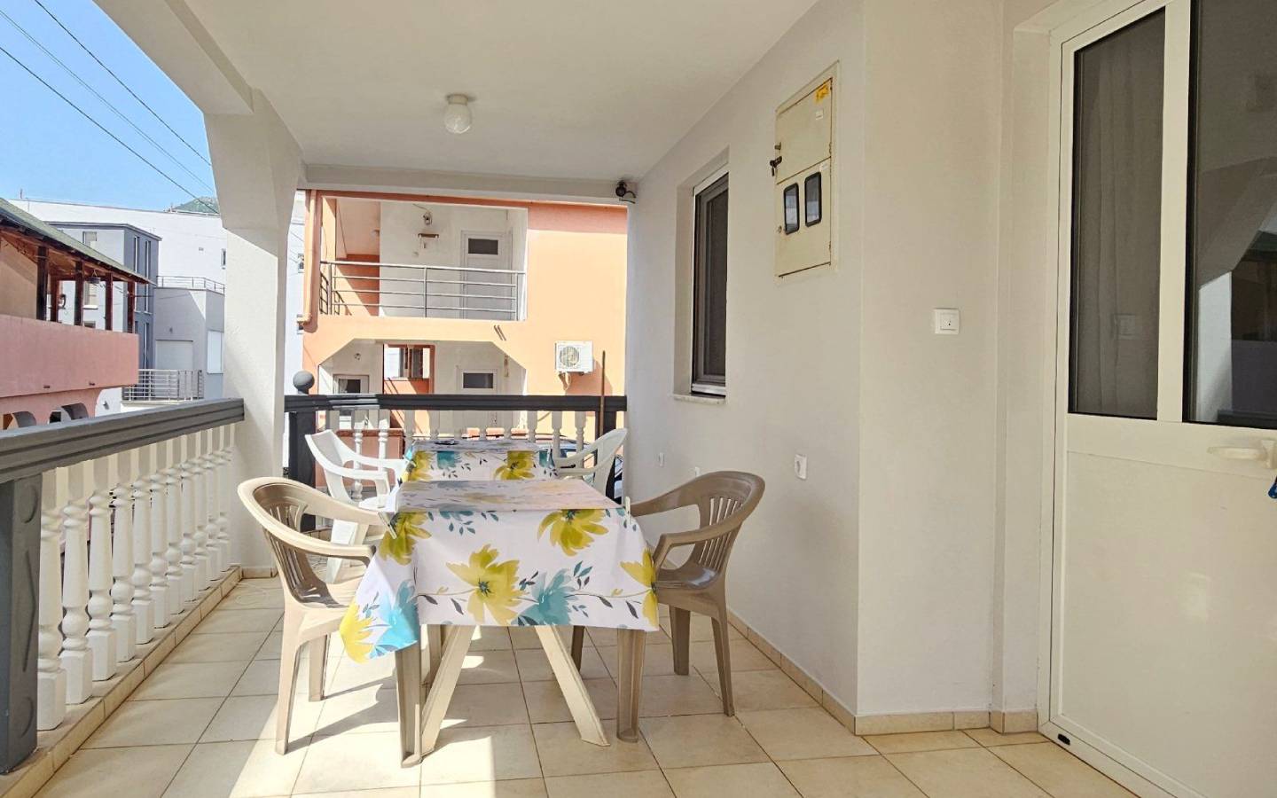 Spacious covered balcony in Ulcinj, Montenegro with beige tiles, perfect for investment&mdash;browse more with immobilien.ekosphere.me by Ekosphere.