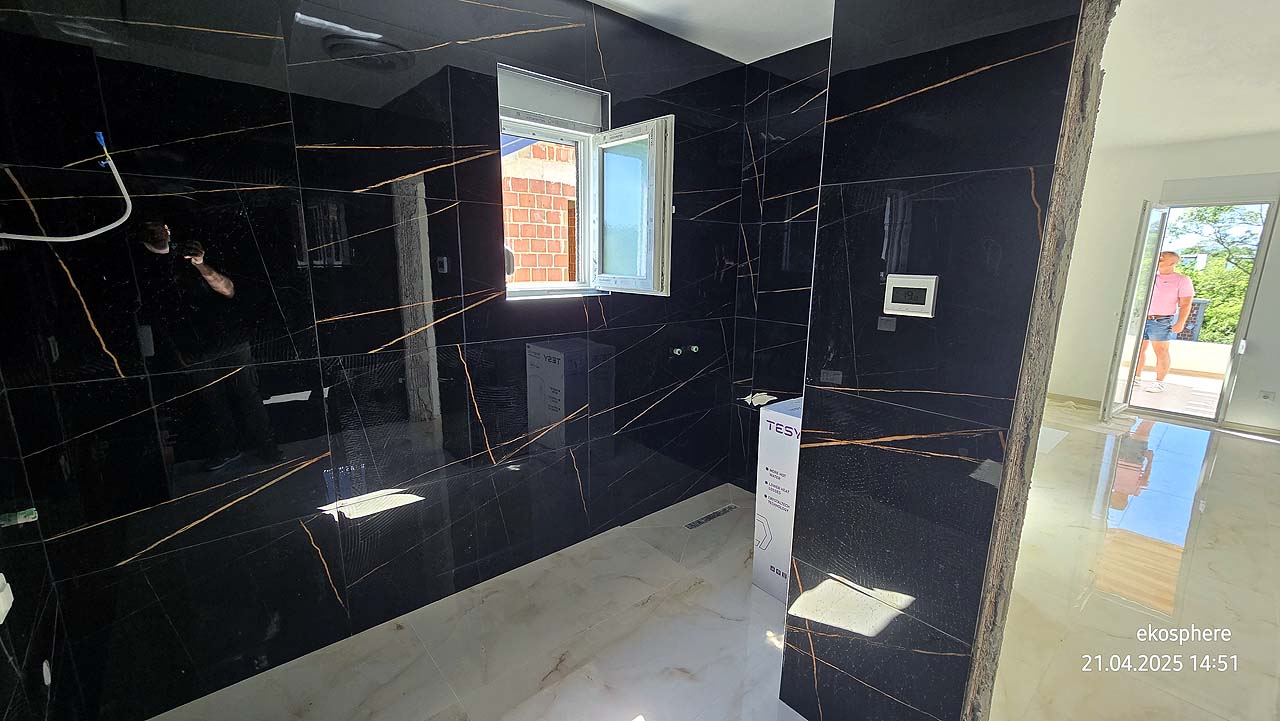 Under-construction Ulcinj property with sleek black tiled walls & sunlit space&mdash;prime investment via immobilien.ekosphere.me by Ekosphere.