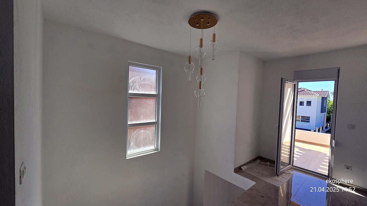 Modern stairwell with white walls, ceiling light, balcony access and Ulcinj views&mdash;ideal property on immobilien.ekosphere.me by ekosphere doo.