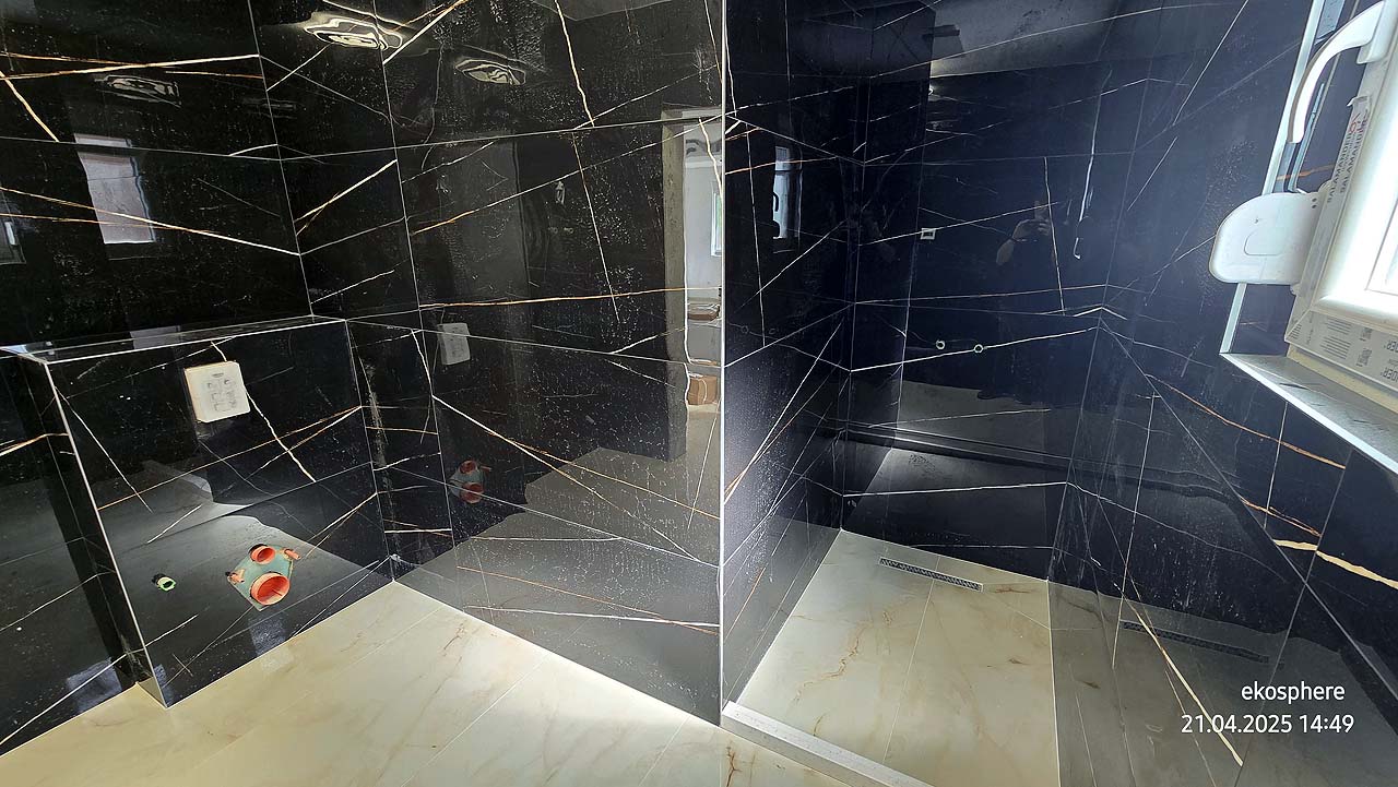 Luxury bathroom in Ulcinj: black marble walls, bright marble floors, walk-in shower, sunny window. Exclusive at immobilien.ekosphere.me by Ekosphere doo.