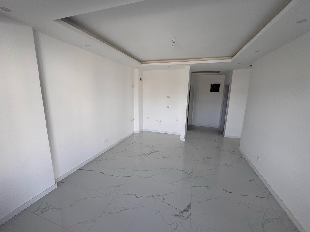 Modern, sunlit Ulcinj property with white walls, chic ceiling, marble floors&mdash;exclusive at immobilien.ekosphere.me by ekosphere doo.