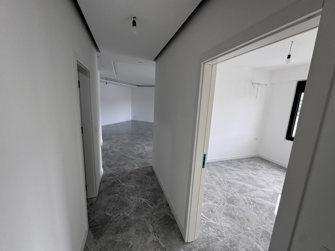 Modern Ulcinj property with elegant grey marble floors, large windows, and bright interiors&mdash;exclusive on immobilien.ekosphere.me by ekosphere doo.
