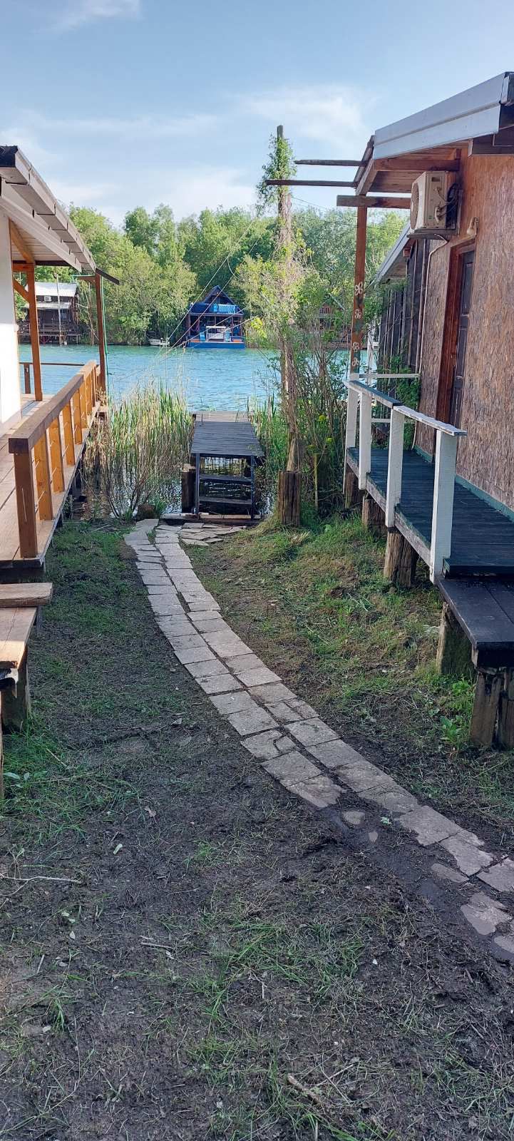 Charming Ulcinj riverfront real estate with stone path, dock, and scenic views&mdash;ideal property investment via immobilien.ekosphere.me by ekosphere doo.