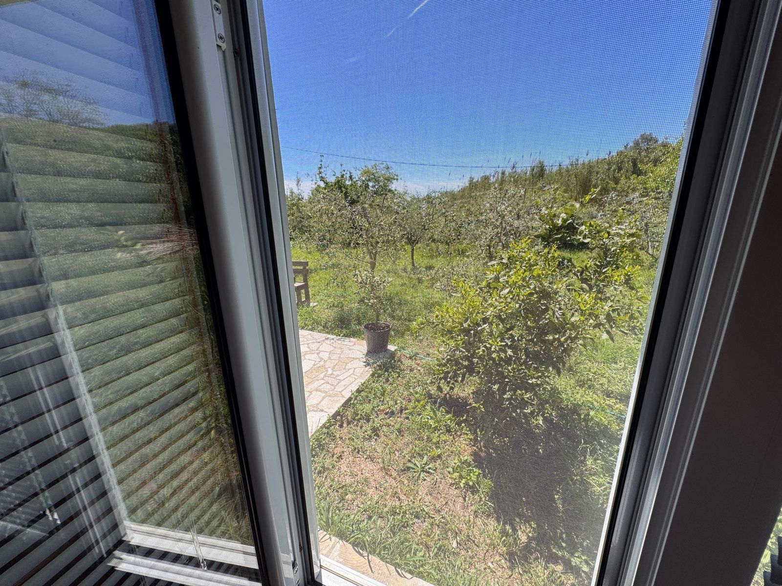 Stunning garden view from stone patio in Ulcinj, Montenegro. Exclusive Ekosphere listing on immobilien.ekosphere.me&mdash;prime investment!.