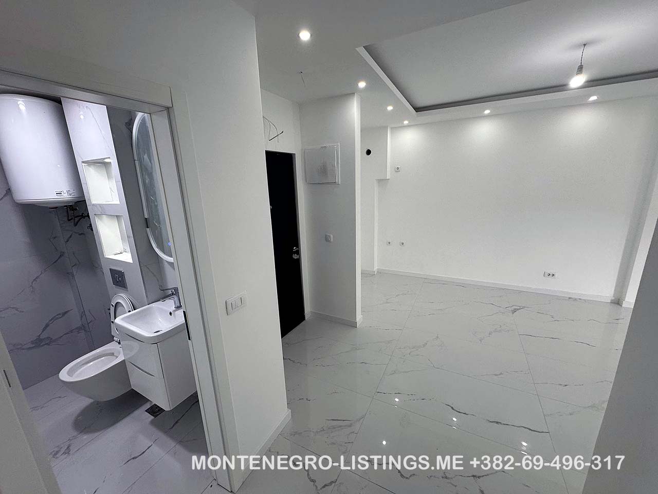 Sleek, unfurnished Ulcinj apartment with marble tiles, recessed lighting, modern bath. Prime Montenegro investment via ekosphere doo.