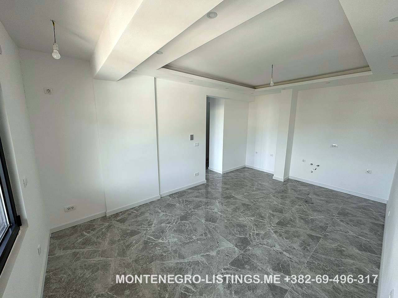 Spacious, sunlit room in Ulcinj with marble floors, large window&mdash;prime Montenegro property via immobilien.ekosphere.me by Ekosphere doo.