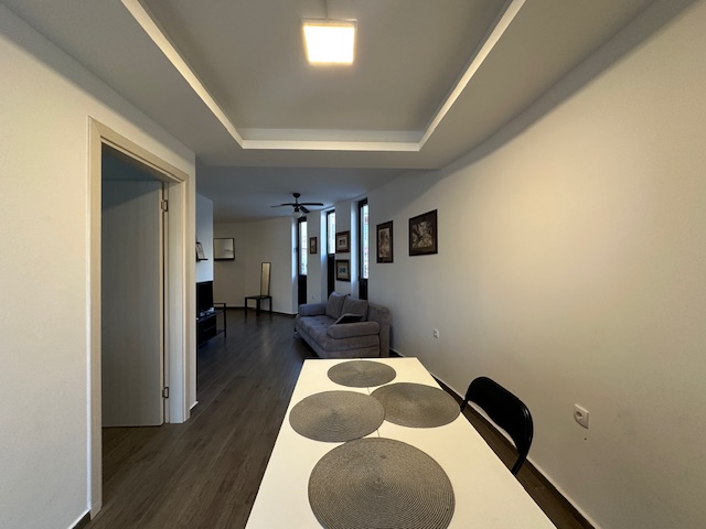 Modern dining area with white table, elegant living room, and premium finishes&mdash;exclusive Ulcinj property at immobilien.ekosphere.me by Ekosphere Doo.