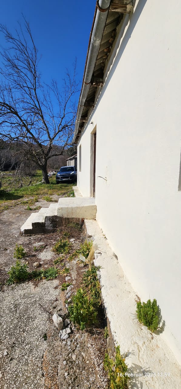 Modern beige building with concrete steps, set amid open greenery under Ulcinj&rsquo;s blue sky&mdash;exclusive on immobilien.ekosphere.me by ekosphere doo.