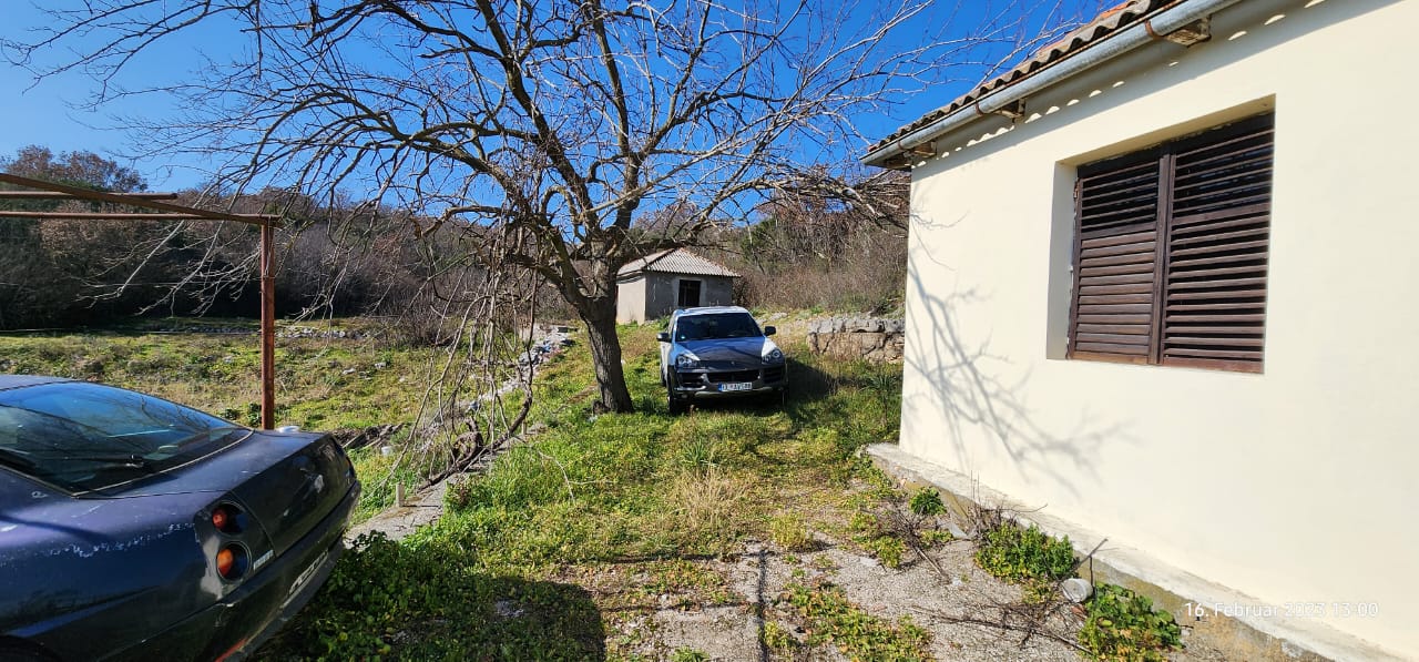 Charming Ulcinj property with parking, brown shutters, sunlit lawn, and shed&mdash;prime investment on immobilien.ekosphere.me by ekosphere doo.