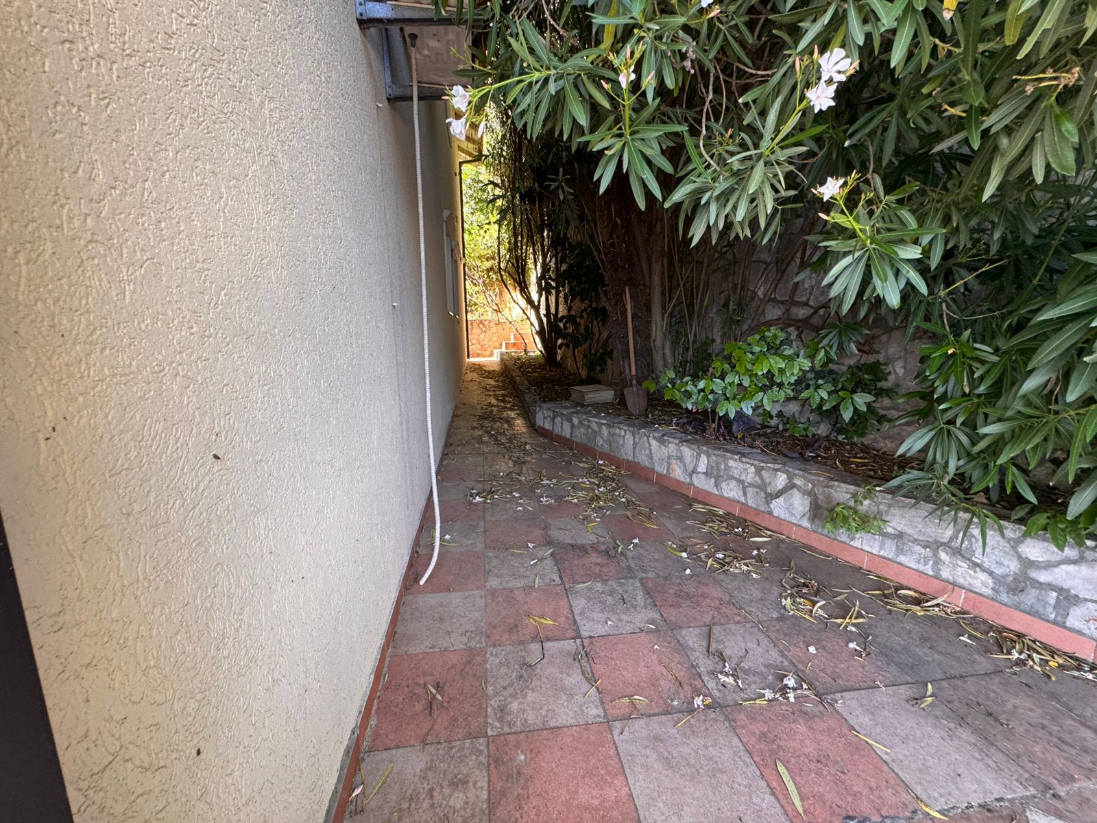 Charming tiled pathway in Ulcinj, Montenegro&mdash;ideal for serene living or investment. Listed on immobilien.ekosphere.me by ekosphere doo.