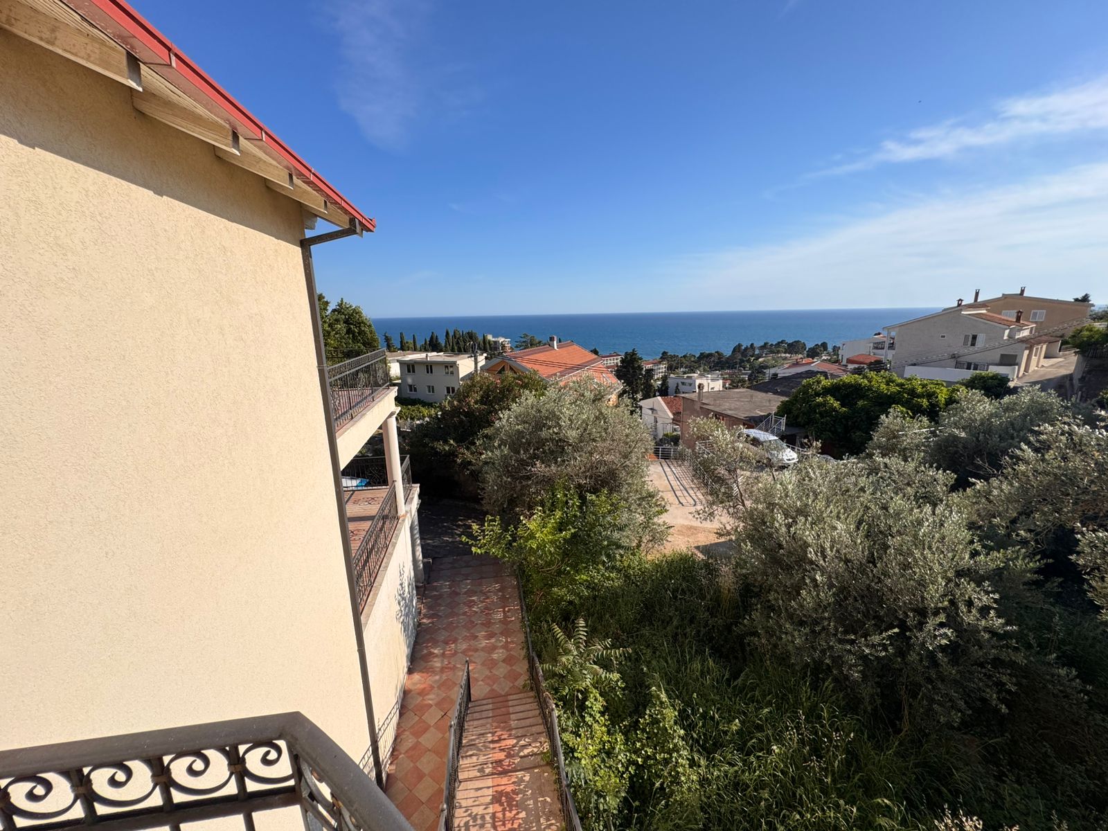 Stunning balcony view over Ulcinj real estate: beige building, lush greenery, sea views&mdash;prime investment via immobilien.ekosphere.me by ekosphere doo.