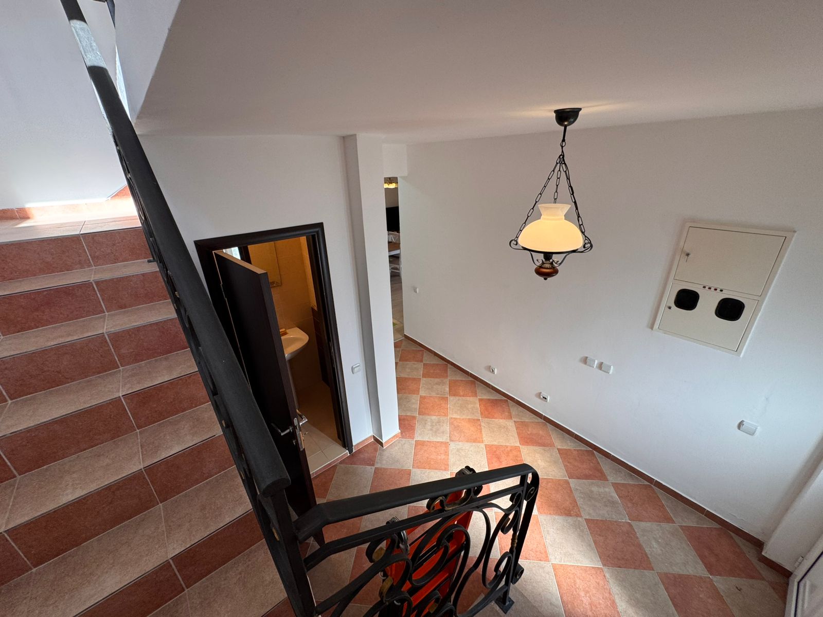Elegant staircase view of an Ulcinj property with stylish tiles, metal rails, and open doors&mdash;exclusive on immobilien.ekosphere.me by Ekosphere doo.