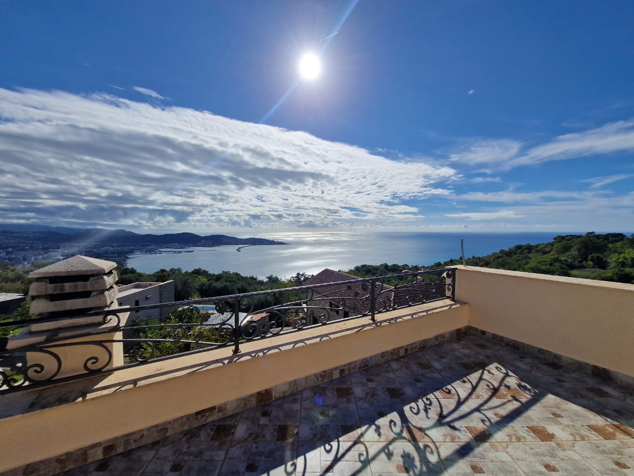 Stunning tiled terrace in Ulcinj with panoramic bay, hillside, and rooftop views&mdash;prime Montenegro real estate by Ekosphere on immobilien.ekosphere.me.
