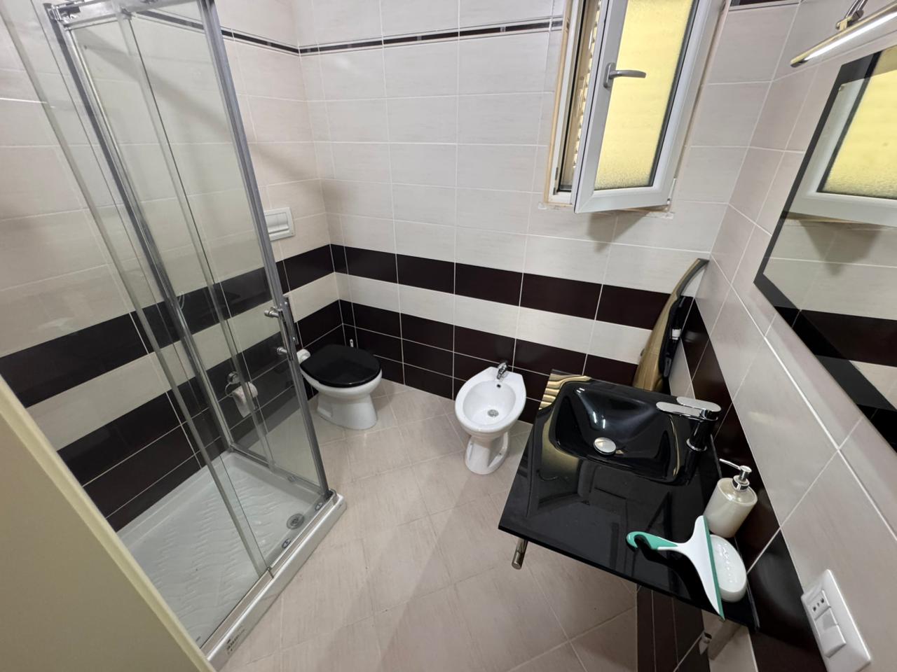 Contemporary Ulcinj bathroom: glass shower, bidet, luxe sink, modern tiles. Exclusive on immobilien.ekosphere.me by ekosphere doo.