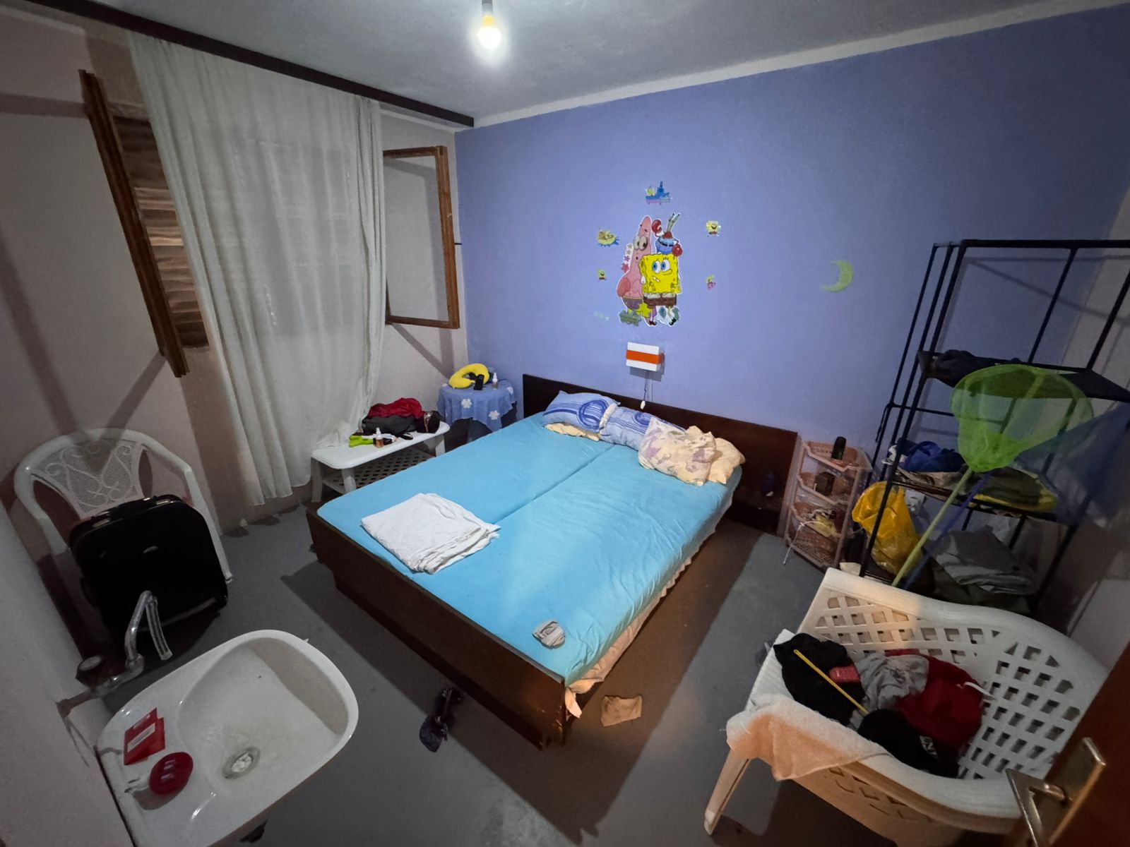 Contemporary Ulcinj bedroom with blue accents, double bed, open window. Invest in Montenegro real estate at immobilien.ekosphere.me.