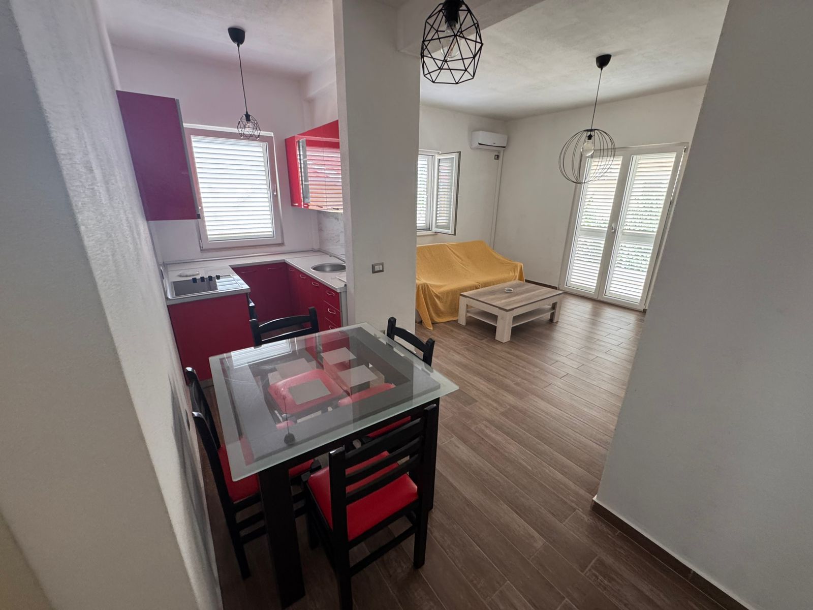 Discover this modern Ulcinj apartment with a red kitchen, bright living area, large windows&mdash;an ideal Montenegro investment by ekosphere doo.