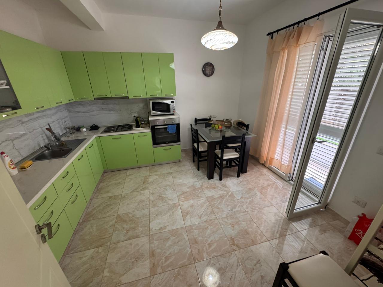 Modern Ulcinj kitchen for sale: light green cabinets, new appliances, terrace access&mdash;exclusive Ekosphere/ immobilien.ekosphere.me property.
