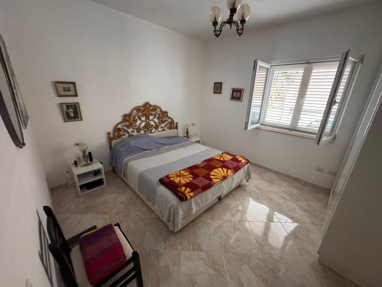 Charming Ulcinj bedroom for sale: elegant double bed, ornate headboard, sunlit space&mdash;ideal Montenegro investment by ekosphere doo.