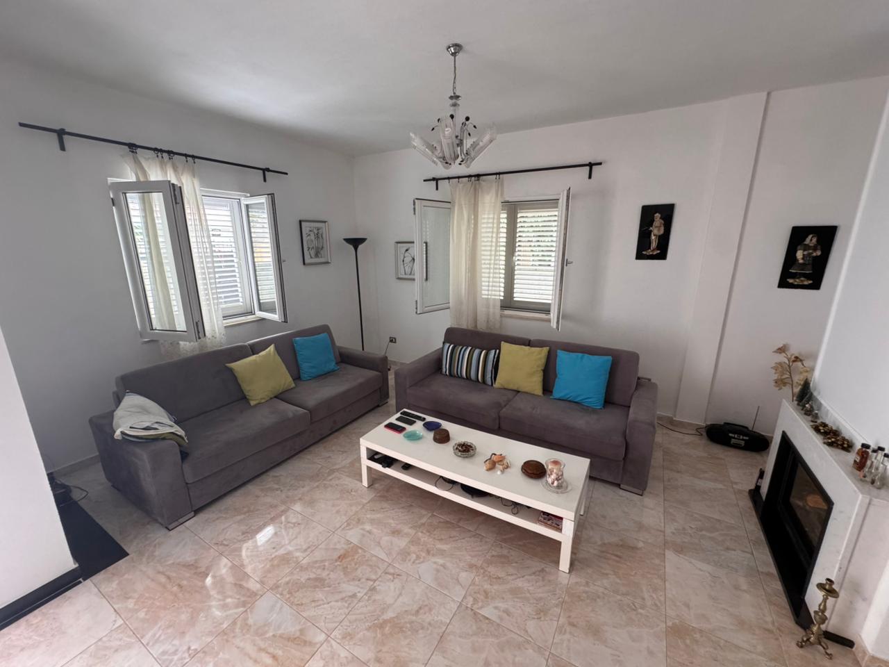 Contemporary Ulcinj living room: 2 gray sofas, chic fireplace, bright windows&mdash;prime real estate by Ekosphere & immobilien.ekosphere.me.