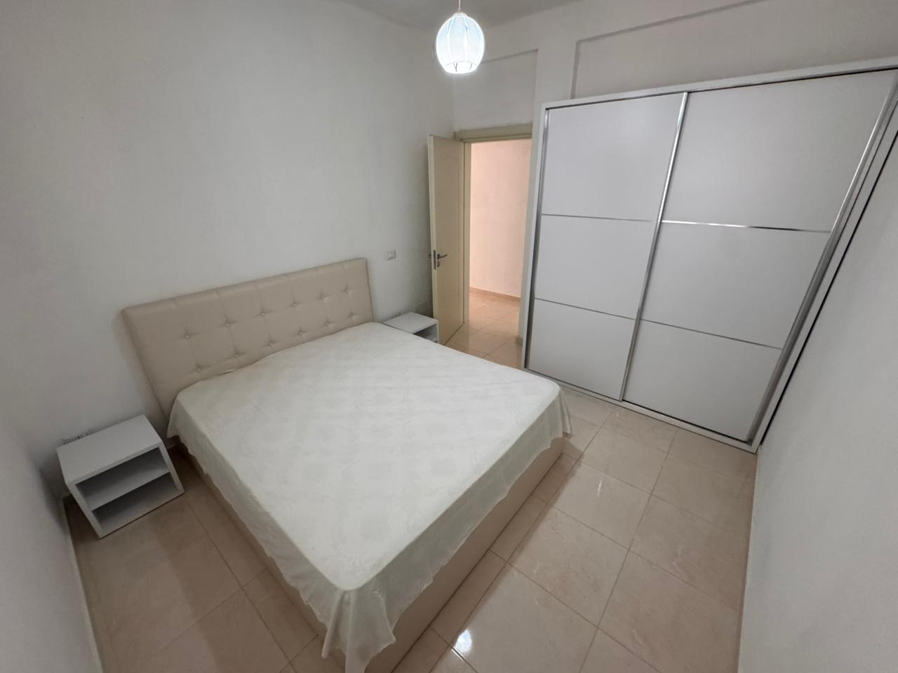 Modern bedroom in Ulcinj: double bed, sleek wardrobe, tiled floors&mdash;ideal Montenegro investment. Exclusive on immobilien.ekosphere.me by Ekosphere doo.