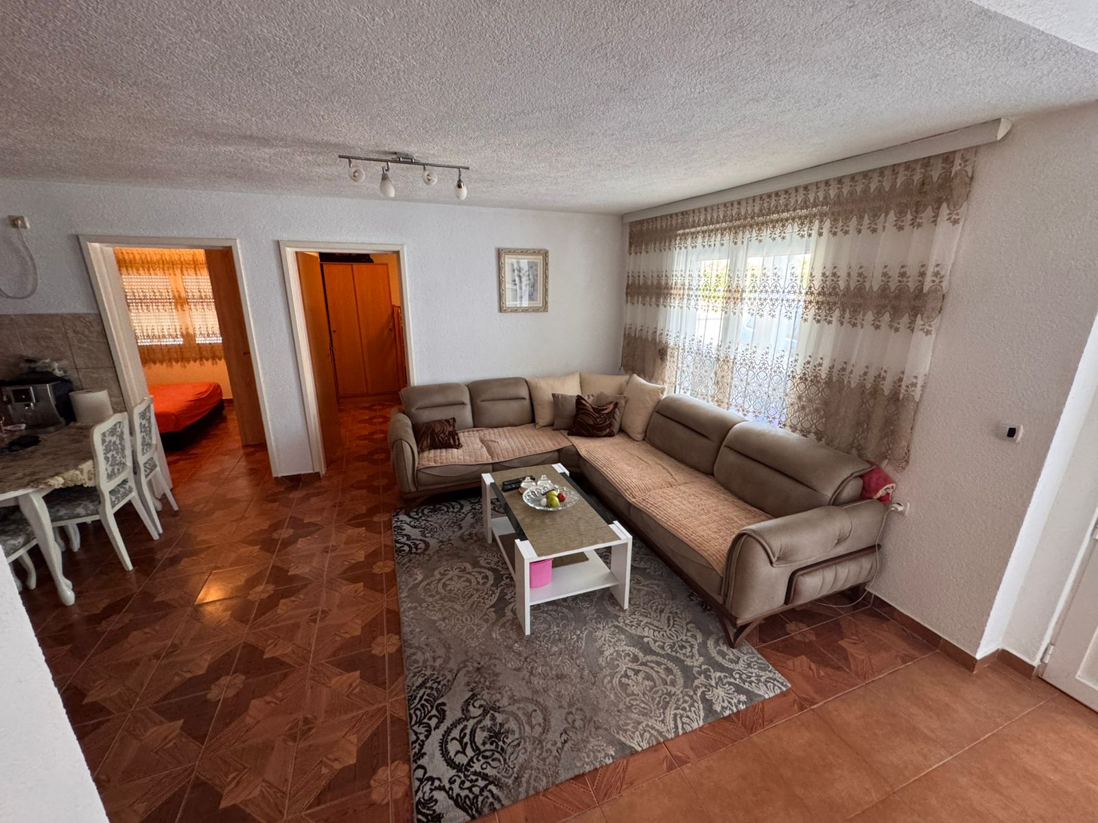 Spacious Ulcinj Montenegro living room with L-shaped sofa, modern decor, and dining area&acirc;exclusive on immobilien.ekosphere.me by ekosphere doo.