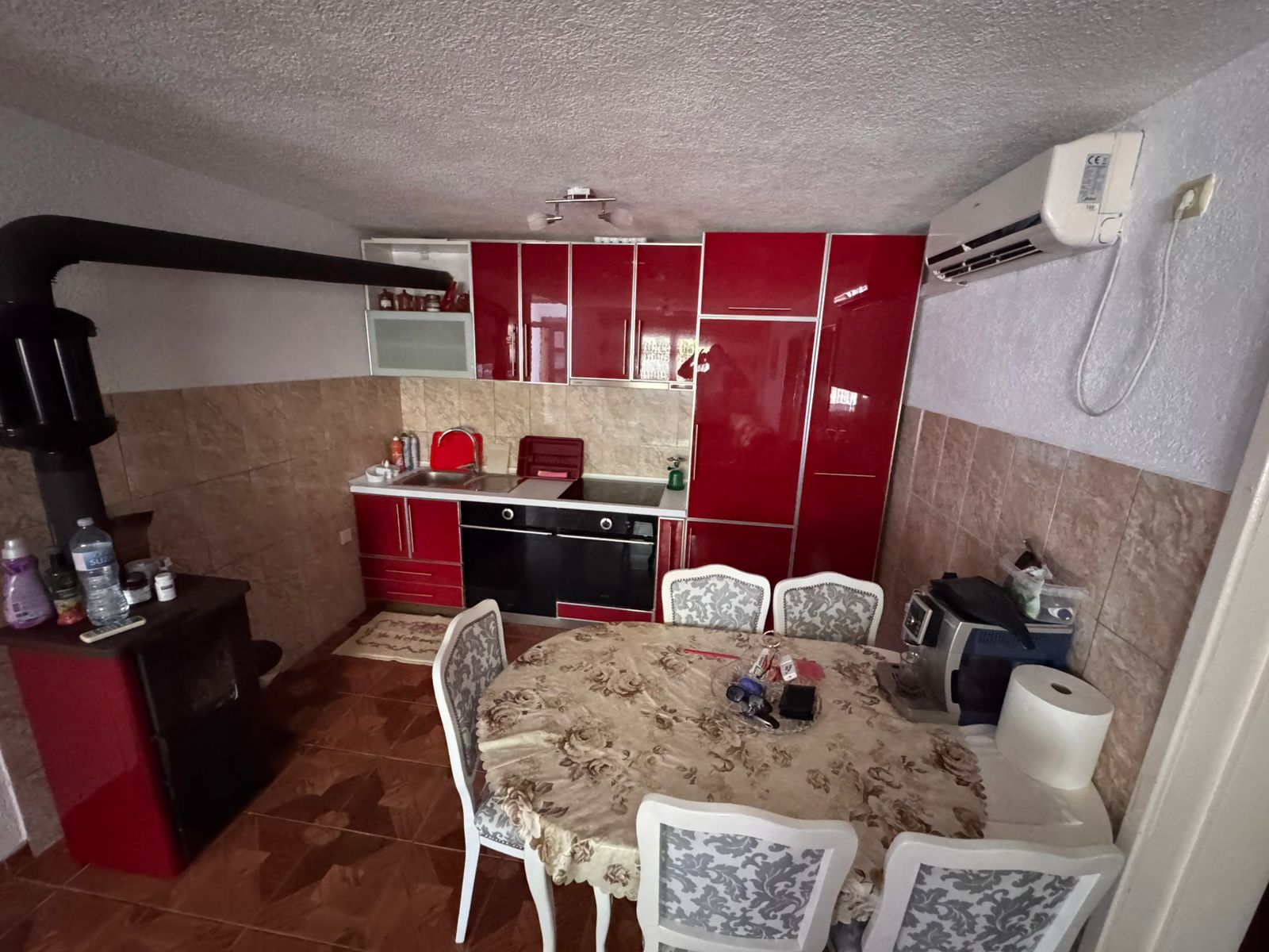 Modern kitchen in Ulcinj with red cabinets, oven, AC, dining set&acirc;ideal Montenegro real estate from Ekosphere on immobilien.ekosphere.me.