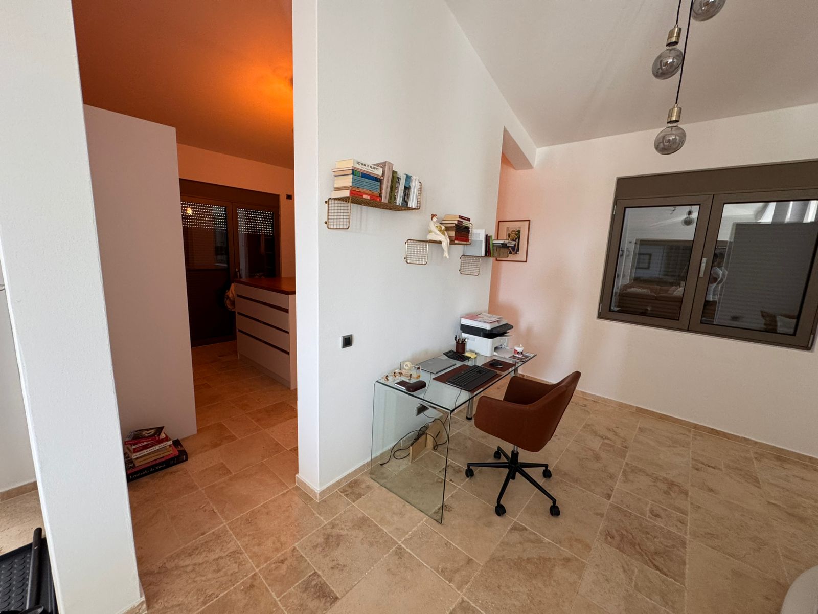 Contemporary home office with glass desk and brown swivel chair in Ulcinj, Montenegro&mdash;prime property by Ekosphere, on immobilien.ekosphere.me.