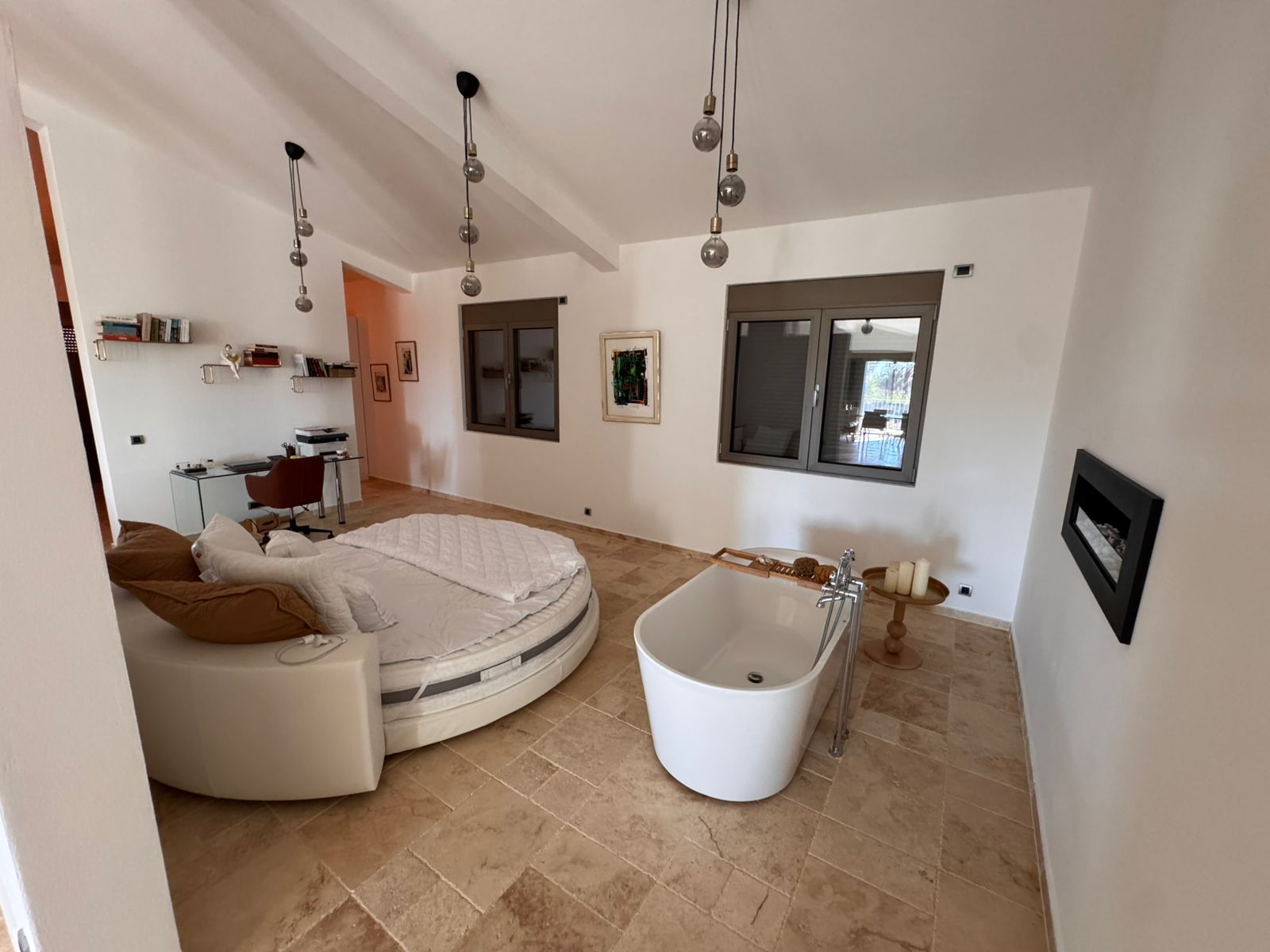 Discover luxury Ulcinj real estate: spacious bedroom with round bed, fireplace, and elegant features. Invest via immobilien.ekosphere.me by ekosphere doo.