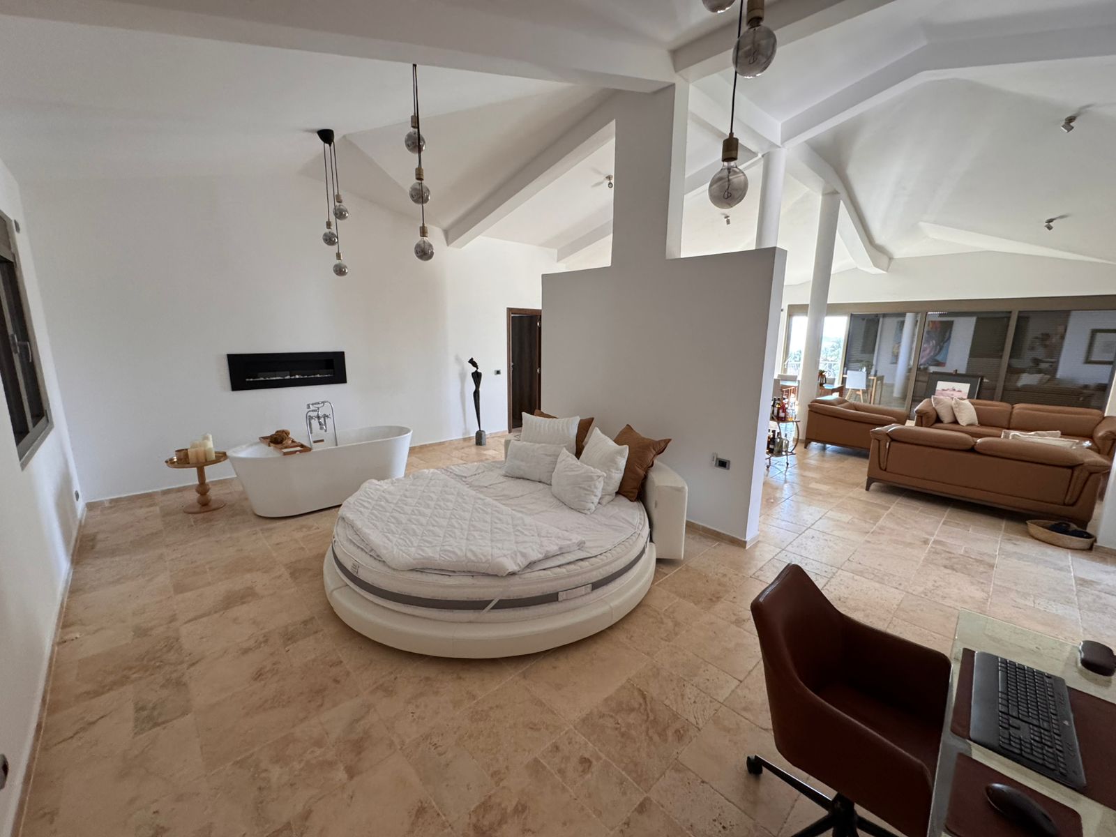 Discover luxury Ulcinj real estate: round bed, elegant decor, fireplace, marble floors&mdash;exclusive from immobilien.ekosphere.me by ekosphere doo.