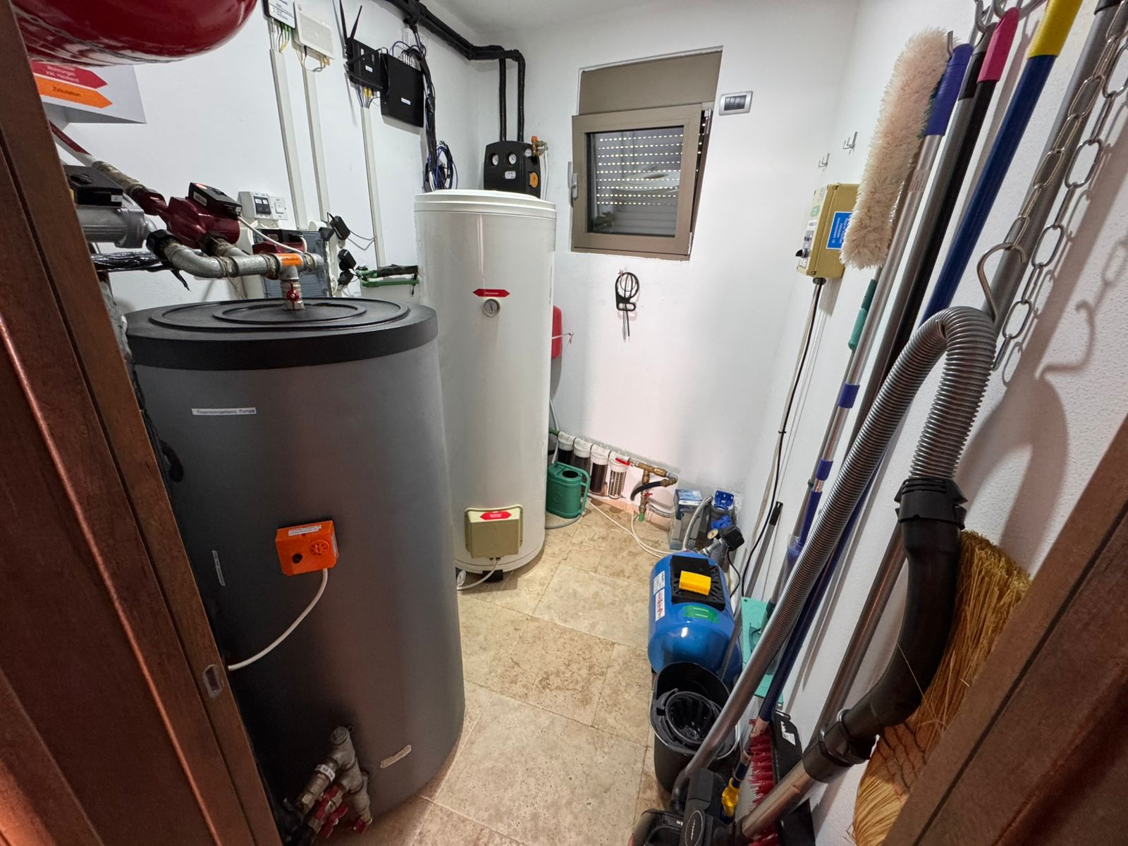 Spacious Ulcinj utility room with dual water heaters, premium fittings, tiled floors&mdash;ideal investment. Exclusive at immobilien.ekosphere.me by ekosphere doo.