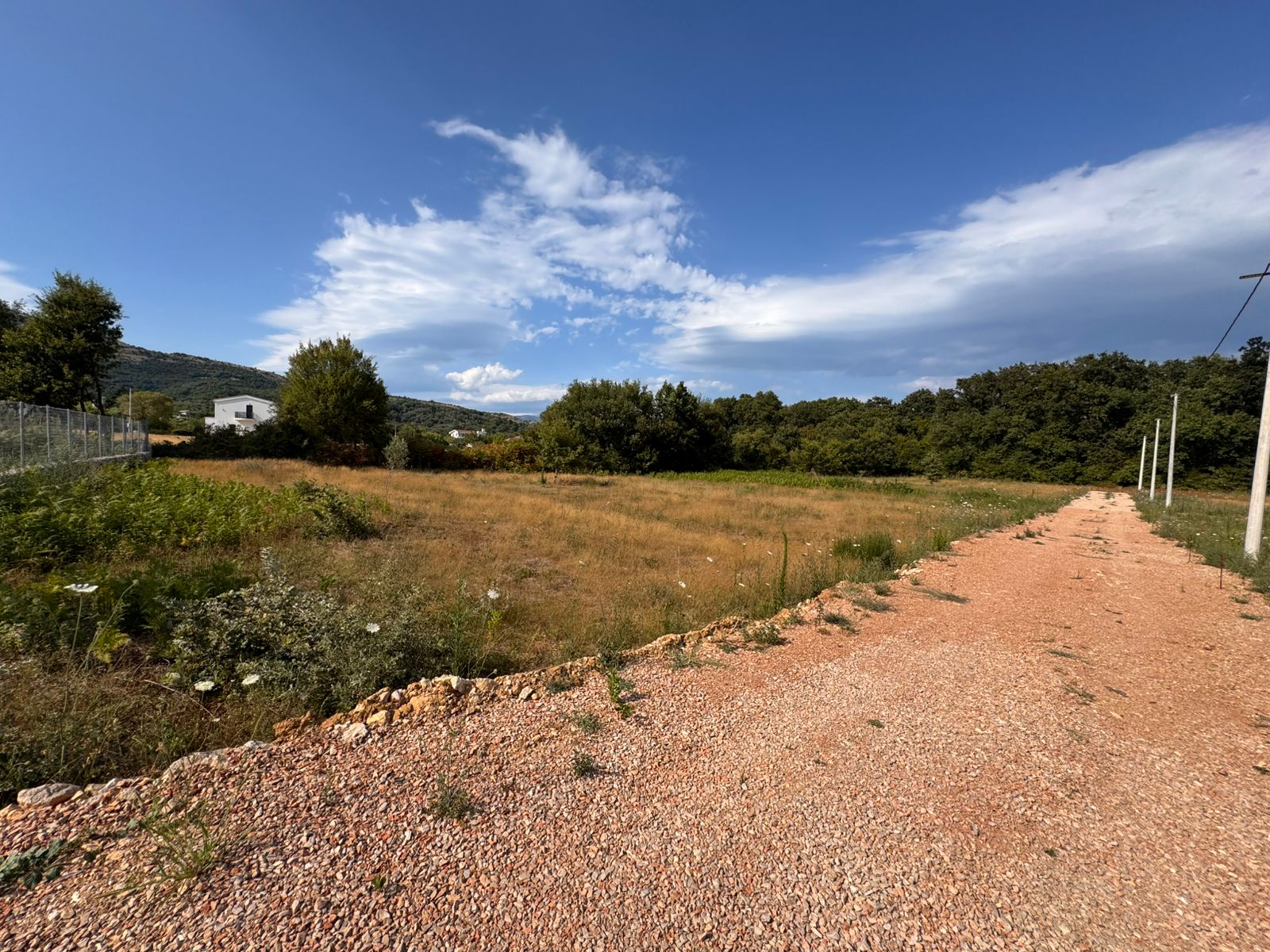 Prime investment opportunity: Open field in Ulcinj, Montenegro with road access, utilities, white house&mdash;exclusive on immobilien.ekosphere.me by ekosphere doo.