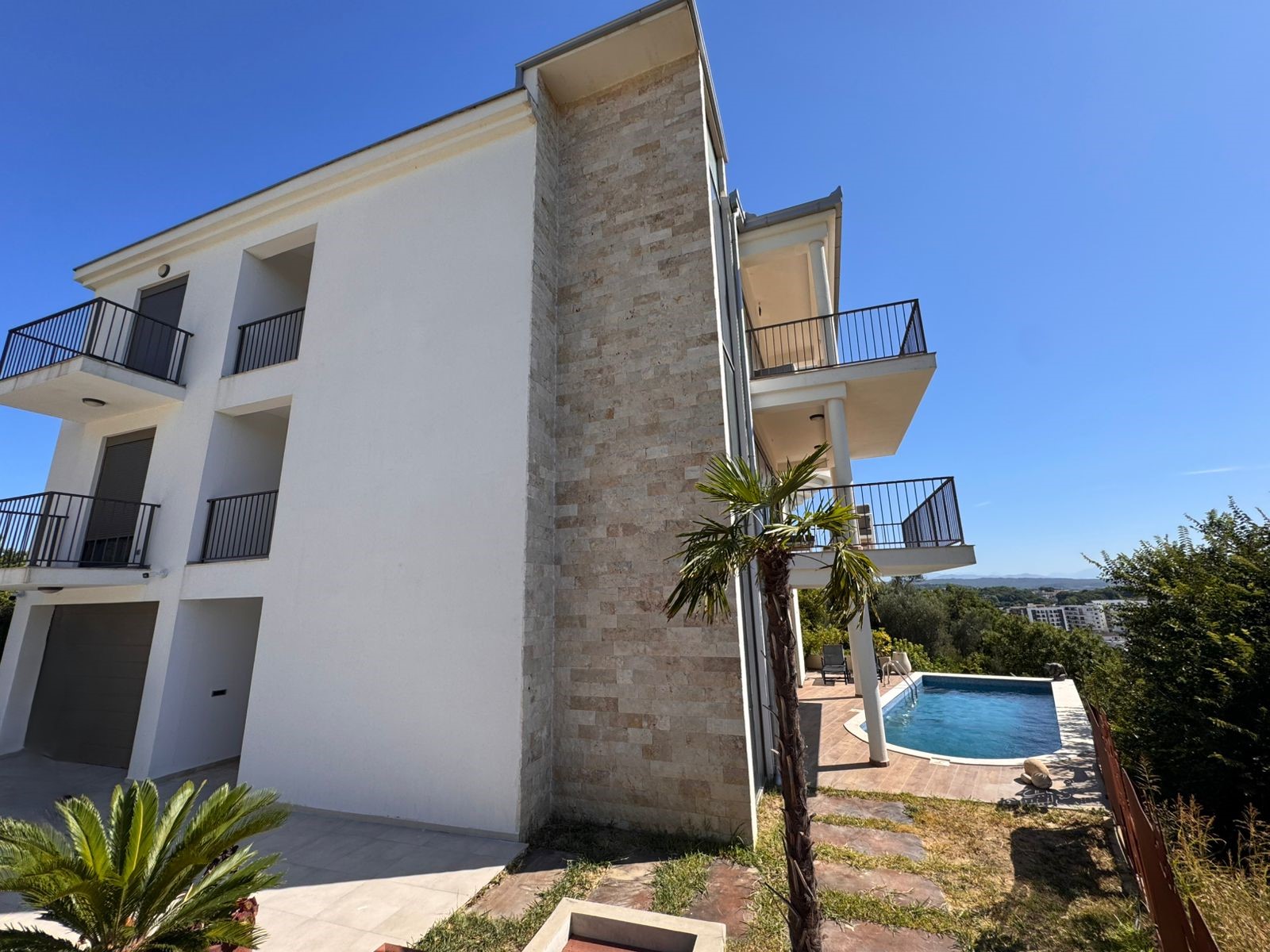 Exclusive three-story eco-friendly property in Ulcinj with balconies, pool, and lush gardens. Listed by immobilien.ekosphere.me (ekosphere doo).