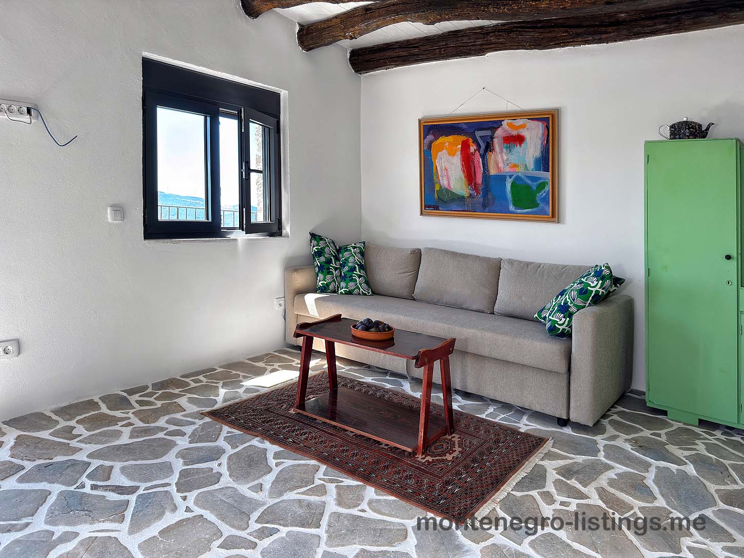 Listings for Sale - Elegant Ulcinj living room with gray sofa, stylish decor, beams; ideal Montenegro investment on immobilien.ekosphere.me by Ekosphere.