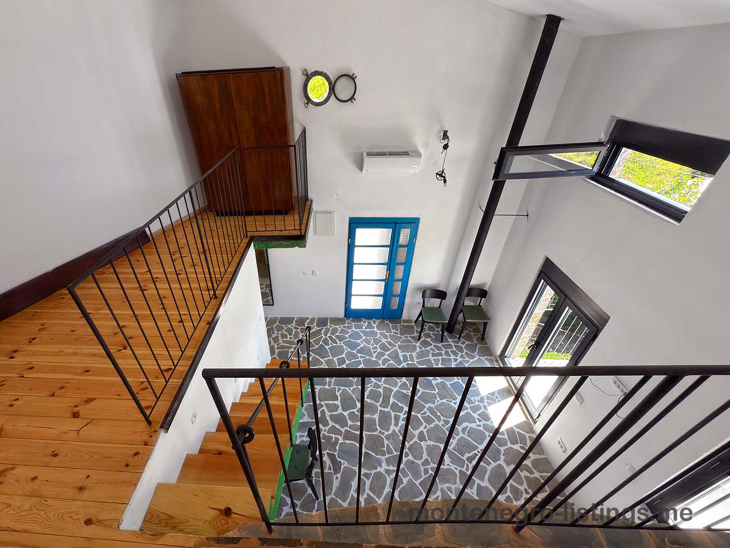 Listings for Sale - Modern open-concept living area in Ulcinj with wood stairs, stone flooring, large windows. Top Montenegro investment&mdash;immobilien.ekosphere.me by ekosphere doo.