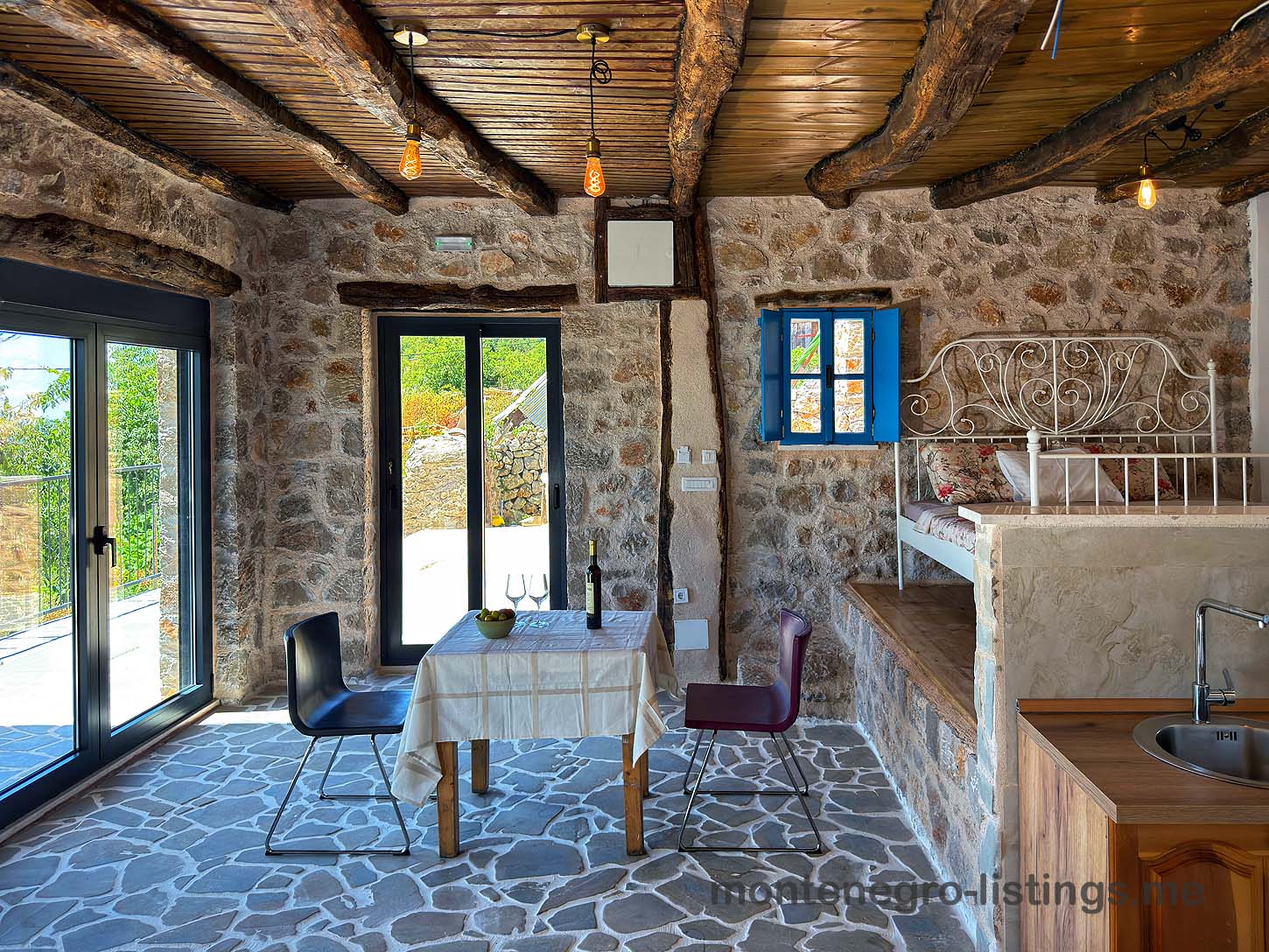 Discover a charming Ulcinj stone-walled home with tiled floors, wood beams, and inviting dining&mdash;an ideal Montenegro investment via ekosphere doo.