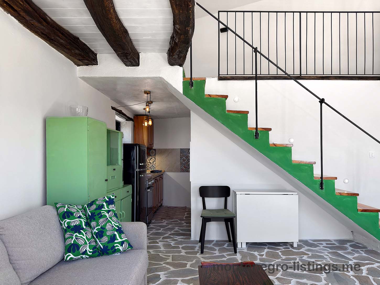 Stylish Ulcinj flat with green kitchen, exposed beams, and patterned tiles&mdash;ideal investment on immobilien.ekosphere.me by ekosphere doo.