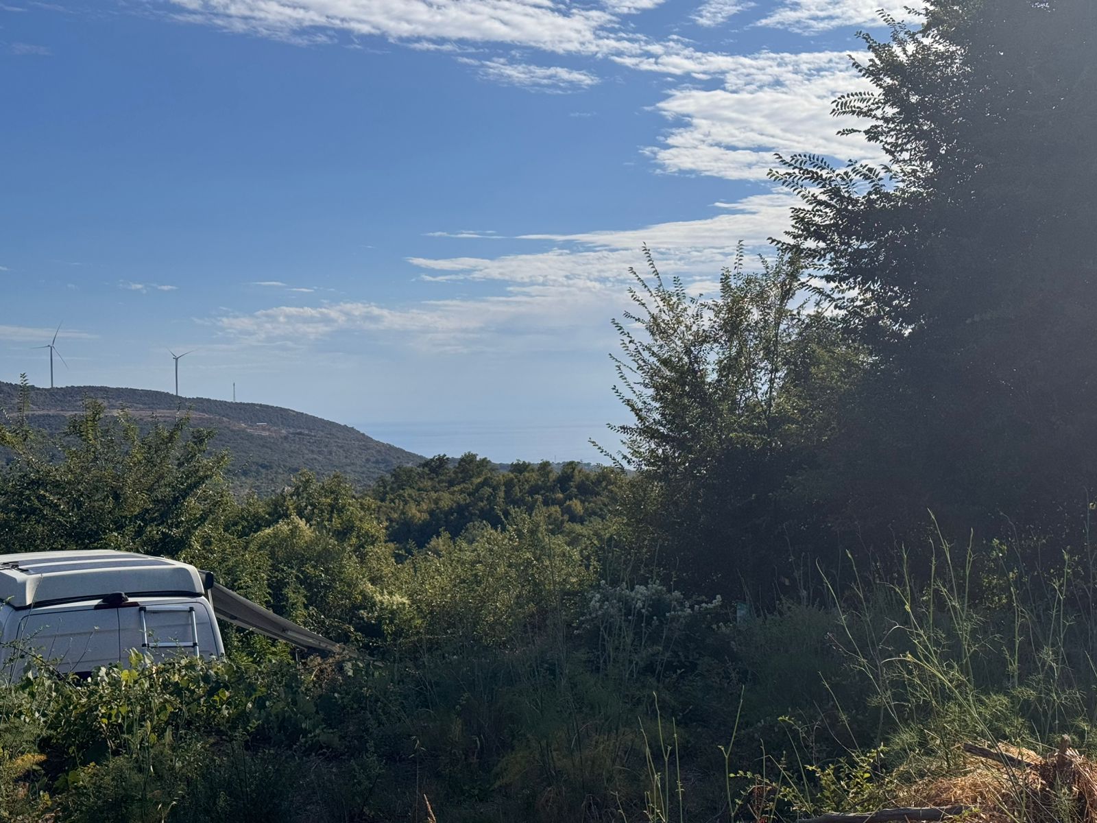 Prime Ulcinj Montenegro real estate site: lush greenery, hills, wind turbines, near properties by ekosphere doo at immobilien.ekosphere.me.